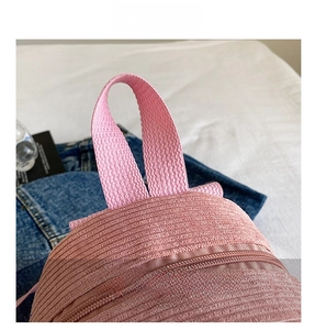 Detail view of pink corduroy fabric texture with reinforced handle and matching zipper