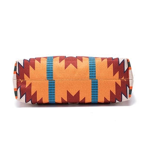 Detailed close-up of geometric ethnic patterns and thick canvas texture on the tote bag