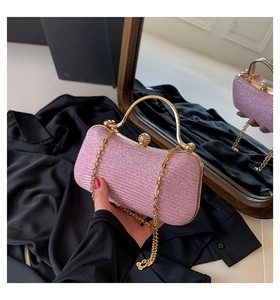 Detailed view of pink sequin evening clutch bag with gold metal handle and chain
