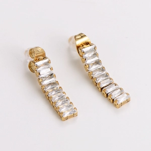 Detailed close-up of gold bar stud earrings featuring rectangular white zircon stones