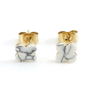 Golden four-leaf clover stud earrings with black marble pattern on white background