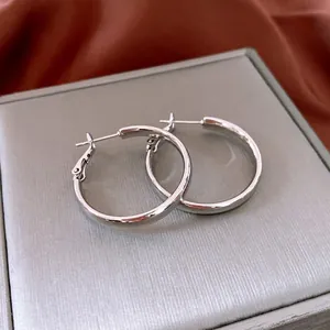 Elegante silberne Creolen mit Hochglanzfinish auf einer hochwertigen Schmuckschatulle