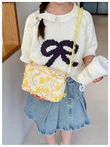 Detail of yellow floral girl's crossbody bag with 3D flower and sequin wave patterns