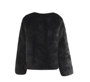 Macro detail of high-density black faux fur texture on a cropped fashion coat