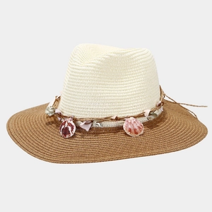 Detail of bohemian straw sun hat featuring seashell accents and two-tone woven textures