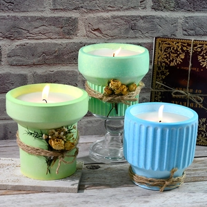 Close-up of ribbed texture silicone candle jars with jute rope and dried flower accents