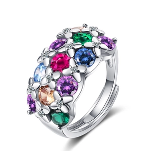Silver flower ring with colorful gemstones and clear crystals on a pure white background