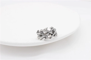 Macro shot of gothic silver thorn pattern ring in vintage polished stainless steel