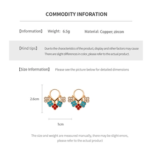 Detail of 18K gold plated flower fringe earrings with red blue and white zircon stones