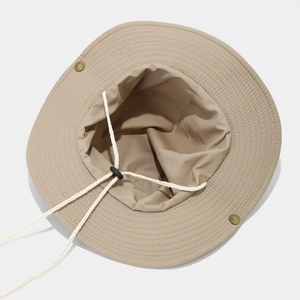 Detail view of khaki bucket hat with adjustable chin strap and metal snap buttons