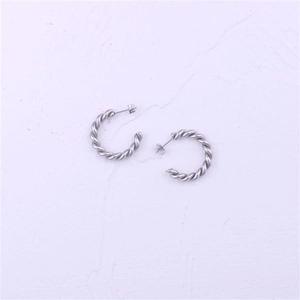 Detailed view of silver twisted rope C-hoop earrings with textured spiral design