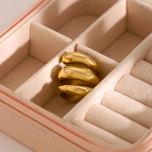 Close-up of 18k gold plated stainless steel triple-layer spring ring in a pink jewelry box