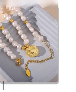Detail of 18k gold plated pendant and freshwater pearls showing the K18 engraving