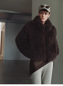 Detailed view of dark brown faux fur vest texture paired with a stylish printed waist scarf
