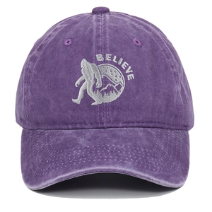 Close-up of BELIEVE Sasquatch embroidery on a purple washed cotton baseball cap