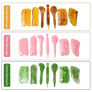 Resin gua sha set with massage combs and tools in amber, pink and emerald green colors