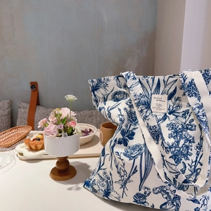 Chic canvas tote bag with blue botanical print and handle for daily aesthetic use