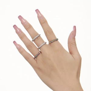 Stackable silver stainless steel rings with colorful zircon and clear stones on model's hand