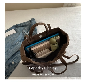 Top view of large brown canvas tote bag showing interior space with everyday essentials