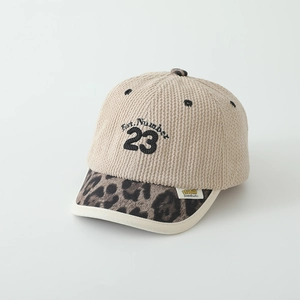 Detailed close-up of corduroy baseball cap with leopard print brim and 23 embroidery