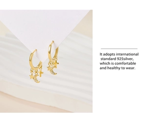Detail of 925 sterling silver gold earrings featuring celestial star and moon dangles