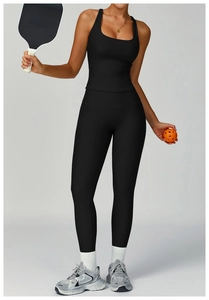 Detail view of black ribbed yoga set featuring a racerback tank top and high waist leggings