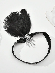 Detail view of 1920s headband with black feathers, silver sequins and beaded tassels