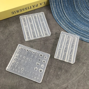 Detail of translucent silicone nail art molds featuring star, heart and bow designs