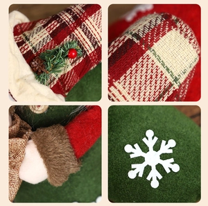 Detail of Christmas stocking with red plaid fabric, pine needles, and white snowflake motif