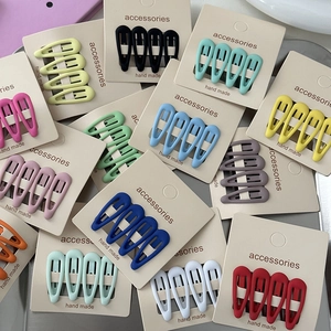 Set of colorful matte star hair clips for girls in various shades on display cards