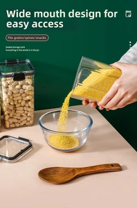 Close-up of food-grade clear storage jars with black sealing lids and grain content