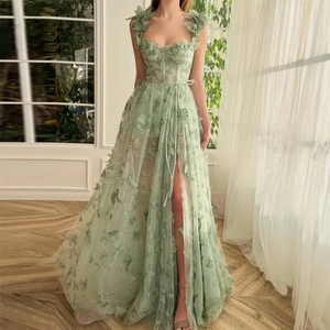 Detailed embroidery of 3D floral lace on light green tulle wedding dress with side slit