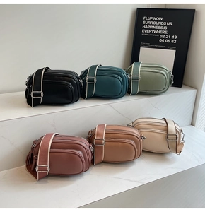 Multi-color PU leather camera bags with wide straps displayed on marble steps