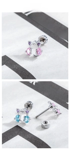 Detailed macro of cat headphone stud earrings with colorful zircons and screw backs