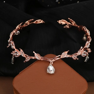 Detailed view of rose gold bridal headpiece with crystal leaves and a pear-shaped drop
