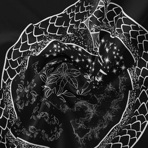 Detailed macro shot of bohemian black fabric featuring intricate white fish scale patterns