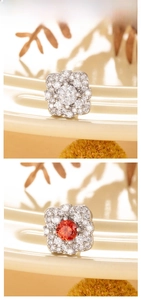 Detail of vintage flower stud earrings with pave-set crystals in white and red colors