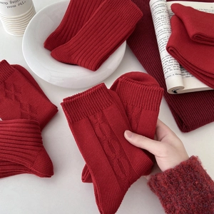 Festive red textured cotton crew socks for women featuring ribbed and cable knit patterns