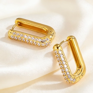 Macro view of gold-plated U-shaped earrings with double-row cubic zirconia inlay