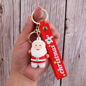 Close-up of Santa Claus PVC keychain with red silicone wristband and golden metal ring