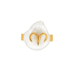 Macro shot of irregular white baroque pearl with gold metal inlay for zodiac ring