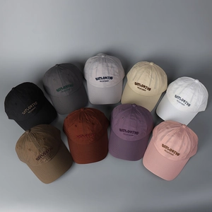 Detail shot of nine assorted color baseball caps with embroidered EXPLOSIVE letters