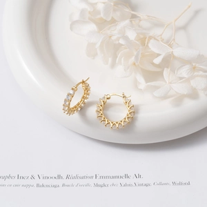Detail of S925 sterling silver gold plated hoop earrings with micro-set zircon stones