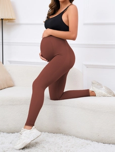 Detail of high-waisted maternity leggings showing belly support and seamless knit texture
