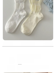 Close-up of ruffled lettuce edge and bow detail on breathable knit cotton socks