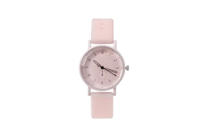 Close-up of soft pink silicone strap and round dial with black numerals for women