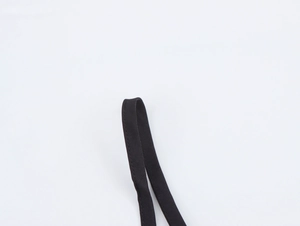 Detailed macro view of high-quality black nylon shoulder strap weaving and stitching