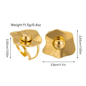 Detailed view of wave-shaped gold earrings with center metal bead and size measurements