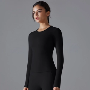 Close-up of black long-sleeved yoga top with slim fit cut and breathable elastic fabric