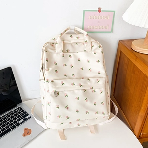 Floral canvas backpack for students featuring pink flower patterns and front zipper pocket